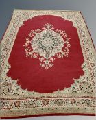 A machine made oriental design rug (as found),