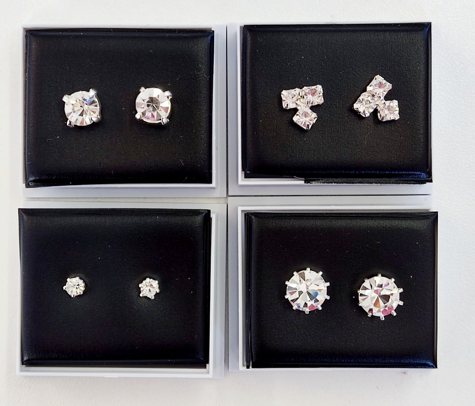 A collection of four pairs of Diamante earrings, in cases.