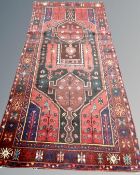 A Kurdish Long Rug, North-West Iran, 294cm by 127cm.