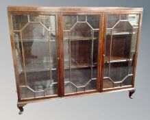 A 20th century mahogany triple door bookcase with astral glazed doors (a/f)