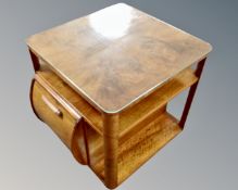 An Art Deco walnut cocktail occasional table.