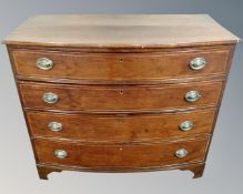 A late George III inlaid mahogany bow fronted four drawer chest.