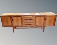 A 20th century teak G Plan four door low sideboard fitted with four central drawers on raised legs.
