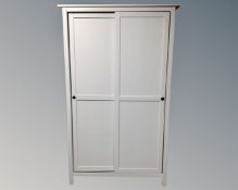 A white IKEA double door sliding wardrobe.
