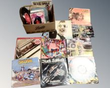 A box of vinyl records including mid century 45s, Iron Maiden, Black Sabbath, The Beatles,