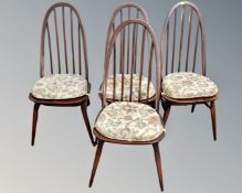 A set of four Ercol stained elm and beech stick back dining chairs