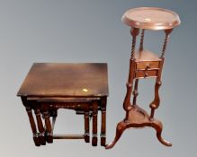 A reproduction mahogany wig stand fitted with two drawers together with a nest of three tables in