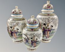 A set of three graduated oriental porcelain lidded vases.