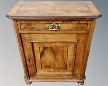 A 19th century continental mahogany and walnut side cabinet, fitted with a drawer above,