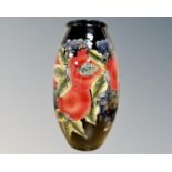 A Moorcroft style pomegranate pattern vase, bears printed signature, height 29.5cm.