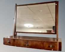 A George III mahogany dressing table mirror on stand, fitted with three drawers.
