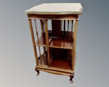 An Edwardian inlaid mahogany and beech revolving book stand.