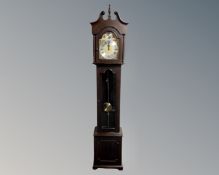 A Tempus Fugit longcase clock with pendulum and weights.