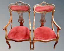 A pair of Edwardian beech open armchairs upholstered in a dralon fabric.
