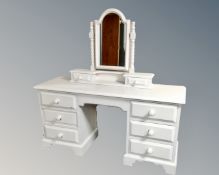 A painted pine seven drawer dressing chest together with mirror on barley twist stand.