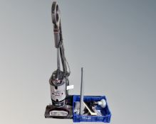 A Shark lift-away upright vacuum together with a crate containing accessories.