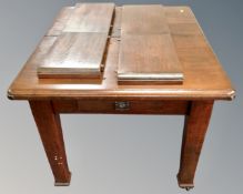 A 19th century pull out dining table fitted with a drawer, with two leaves.