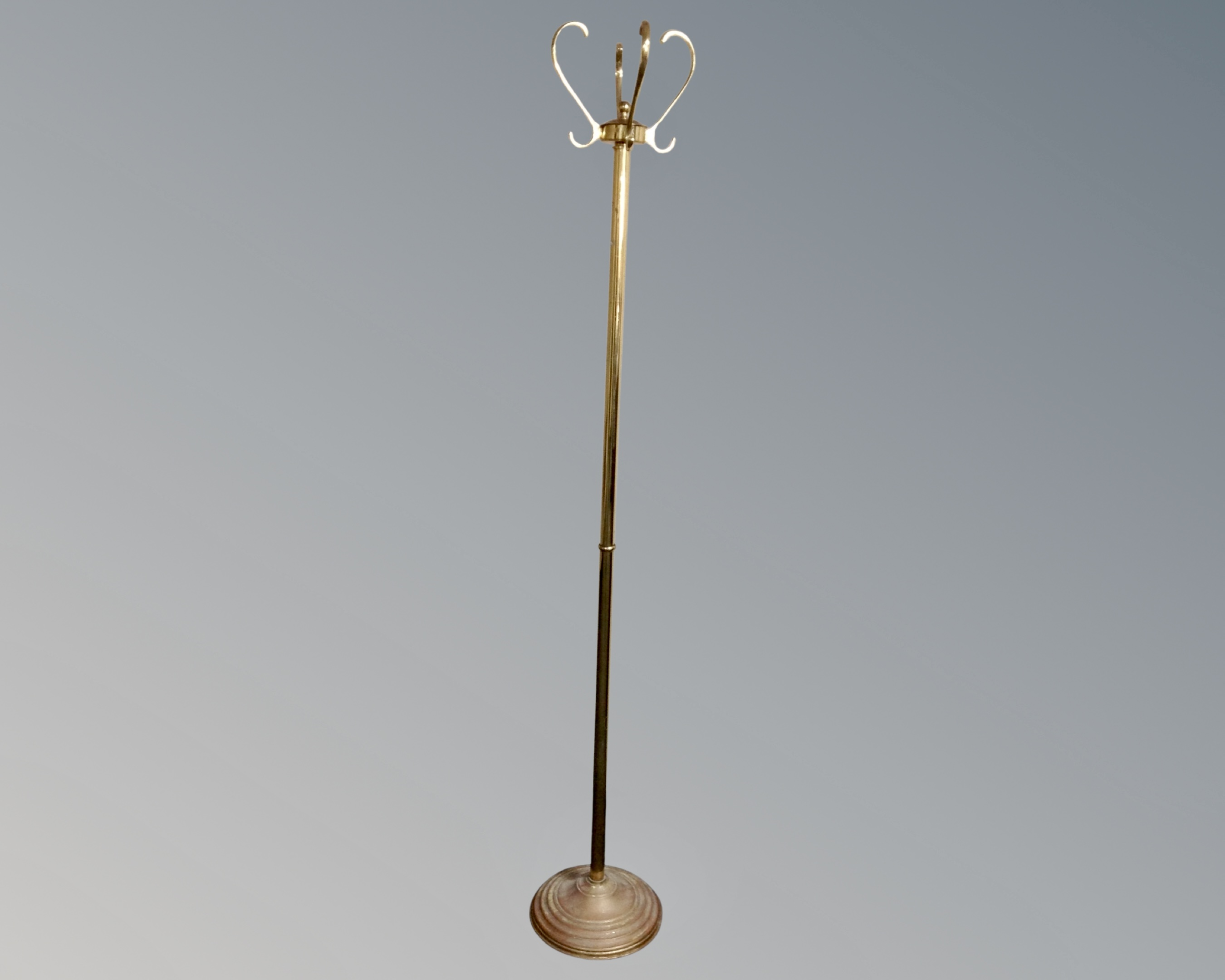 A vintage brass revolving hat and coat stand.