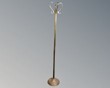 A vintage brass revolving hat and coat stand.