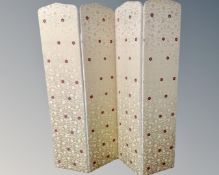 A four -panel fabric upholstered room divider.