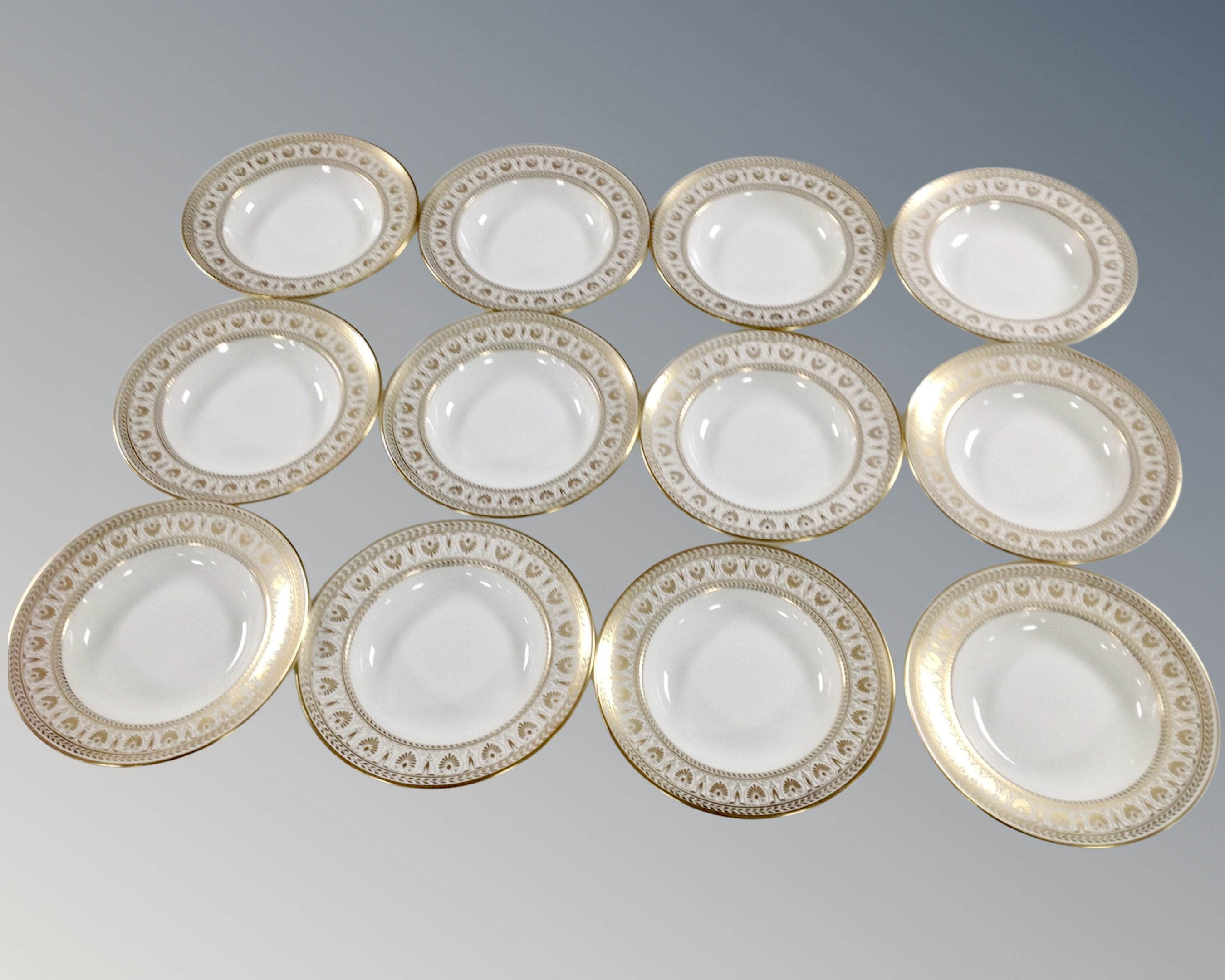 A set of 12 Crown Staffordshire white and gilt bone china bowls.