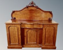 A Victorian mahogany triple door serpentine fronted chiffoniere fitted with central drawe (a/f)