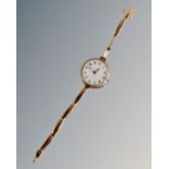 A lady's 9ct gold wristwatch on 9ct gold bracelet, with enamelled dial,