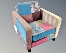 A contemporary armchair upholstered in a patchwork fabric.