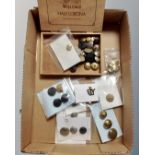 A box of assorted military and transport buttons and badges