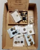 A box of assorted military and transport buttons and badges