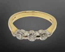 An 18ct gold three stone diamond ring, size K1/2 CONDITION REPORT: 3.