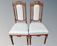 A pair of 19th century heavily carved oak hall chairs.