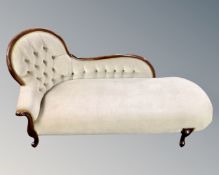 A Victorian style chaise longue upholstered in green button dralon.