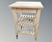 A pine butcher's block trolley.