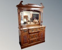 A 19th century walnut break front mirror back sideboard fitted with cupboards and drawers beneath.