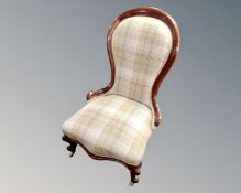 A Victorian mahogany framed nursing chair upholstered in a tartan fabric.