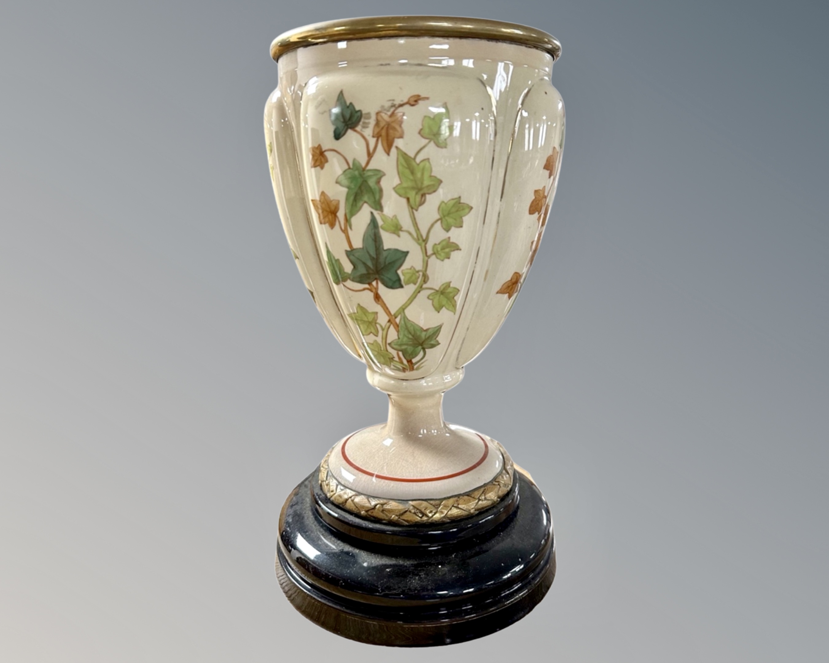 A Victorian transfer printed pottery vase on socle.