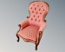 A Victorian mahogany button back armchair.