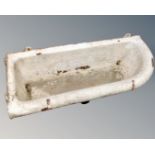 An antique cast iron wall mounted trough.