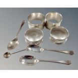 Four silver napkin rings together with three silver teaspoons and a silver mustard spoon.
