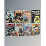 A collection of eight vintage DC The Shadow comics, some in plastic covers.