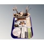 A tray containing stamp packs, enamelled badges, Freemason's badge,