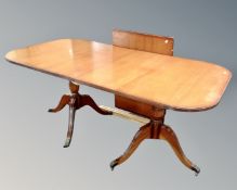 A Regency style mahogany twin pedestal dining table with leaf.