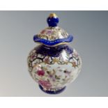 A Chinese style lidded vase decorated with flowers.