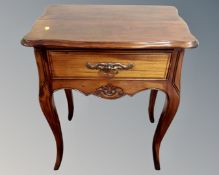 A hardwood side table fitted with a drawer on cabriole legs.