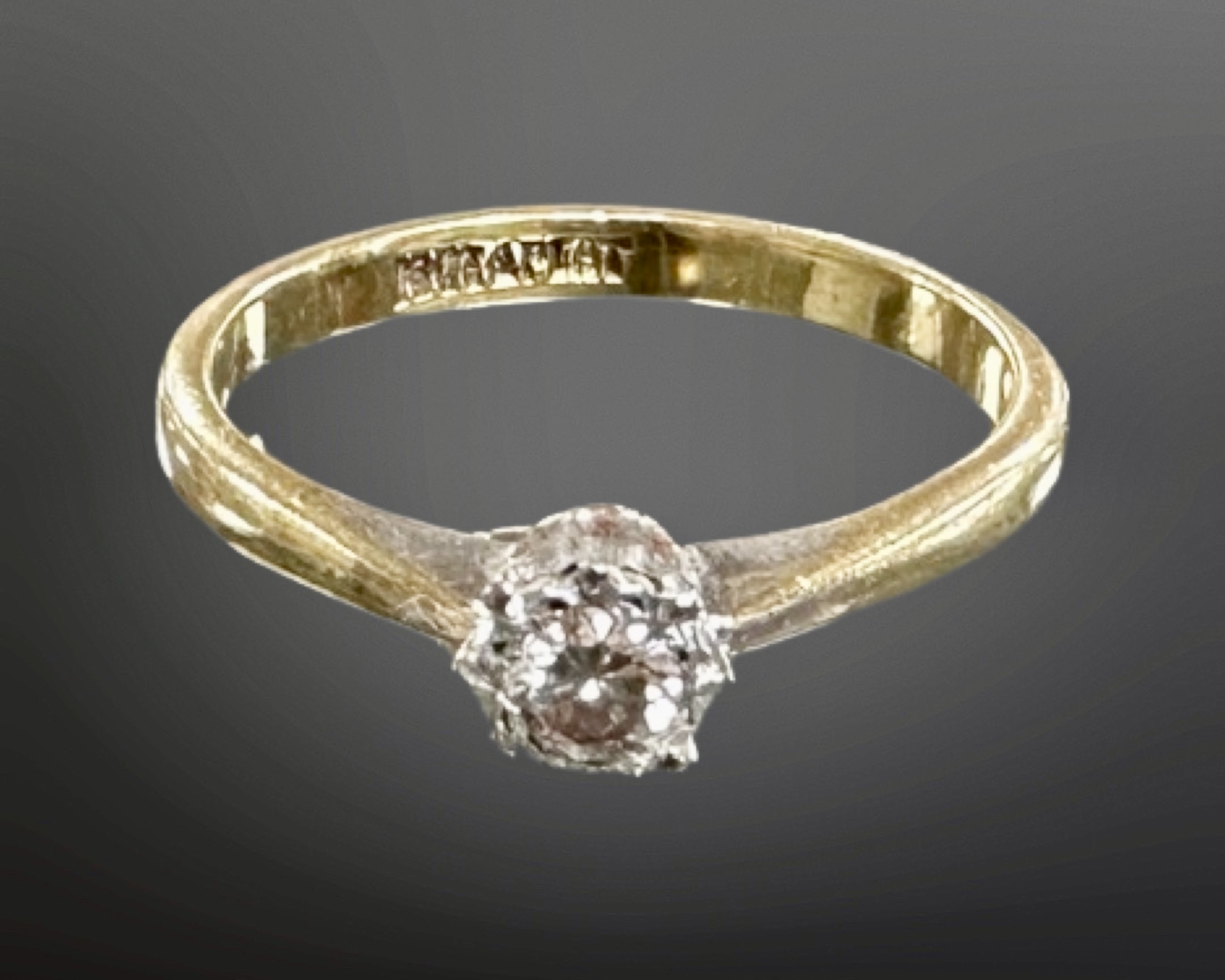 An 18ct gold and platinum solitaire diamond ring. CONDITION REPORT: 2.