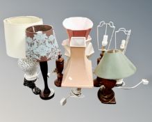 Seven assorted ceramic and wooden table lamps with shades.