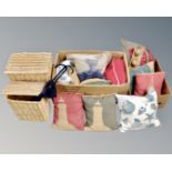 Two boxes containing assorted cushions together with two graduated wicker laundry baskets