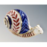 A Royal Crown Derby snail paperweight with porcelain stopper.