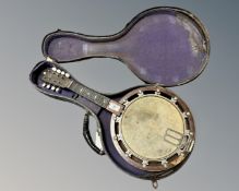 A banjo/mandolin in case.